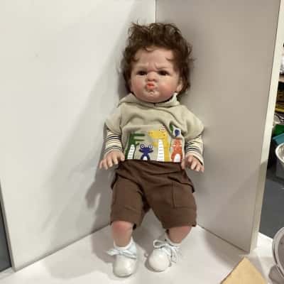 Reborn baby boy doll pouting