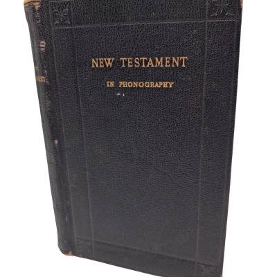 This is an antique copy of The New Testament in Phonography (Pitman's Shorthand), published by Sir Isaac Pitman & Sons in the late 19th or early 20th century. 
