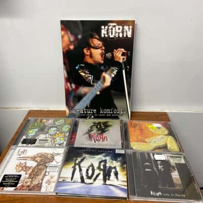 Collection of Korn CDs, DVDs, VHS and book