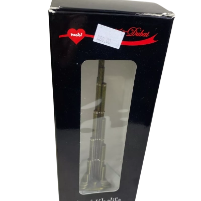 a decorative metal souvenir figurine of the Burj Khalifa skyscraper in Dubai.