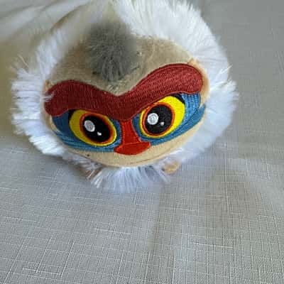 Disney The Lion King Squeezamals plush of the character Rafiki.  It is a soft and squishy stuffed animal. The plush features embroidered details for the character's face. It was part of a limited-time promotion(B14)