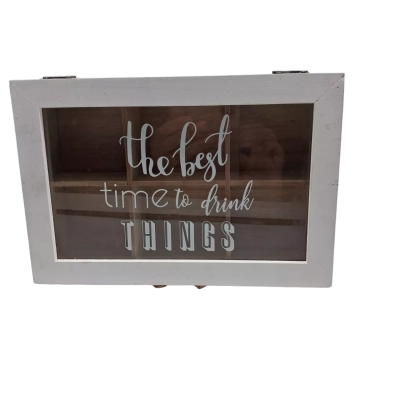 A white-framed wooden compartment box features a glass lid with the playful phrase "the best time to drink THINGS" painted in white script.