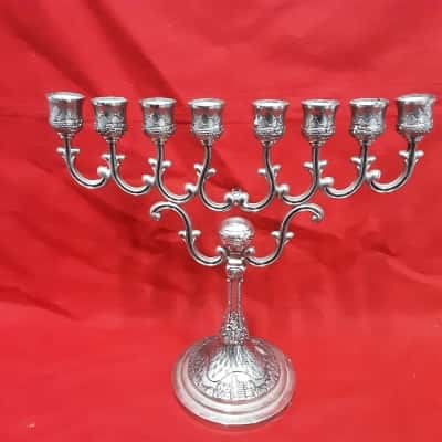 Silver plated vintage Menorah featuring scenes of Jerusalem on the base