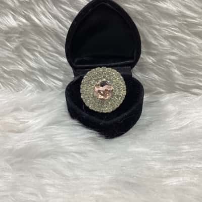 Womens Gold tone adjustable ring with a large pink glass stone & double halo of rhinestones surrounding