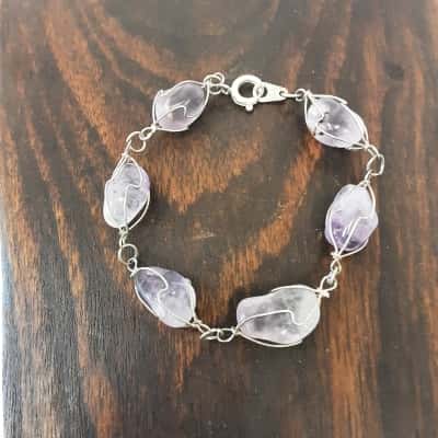 Stylish silver tone cuff bracelet featuring a sleek triple-band design with an open construction for easy wear. The polished finish gives the bracelet a clean, contemporary look, making it a versatile accessory for everyday wear or dressing up an out
