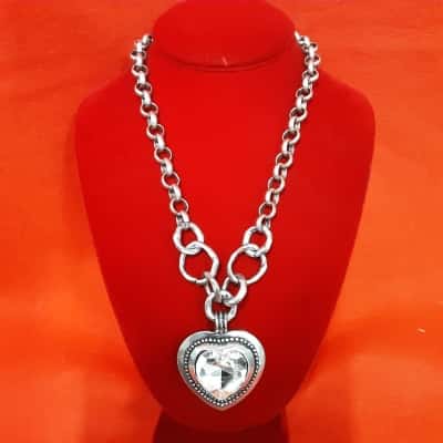 Large statement piece necklace with heart-shaped pendant and cut glass Centre on a rustic hammered look chunky chain