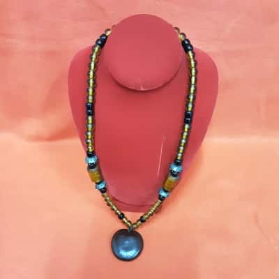 Vintage style boho necklace featuring Amber coloured glass beads and large Central pendant