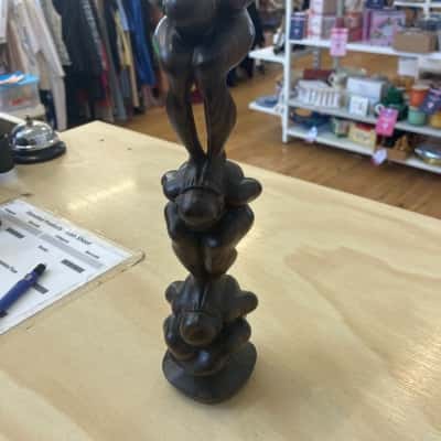 Three crouching figures statue 