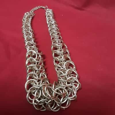 Gold Tone graduated statement necklace featuring an intricate interlock link design