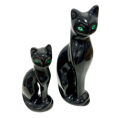 2 large black Cats w/ geeen eyes 