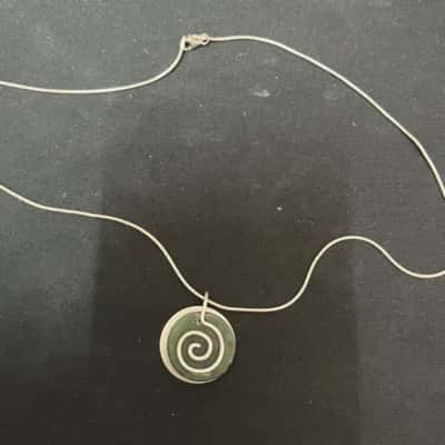 silver necklace with green stone. 