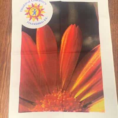 Tea Towel, Bright Orange Gerbera with Disabled Children's Foundation Logo