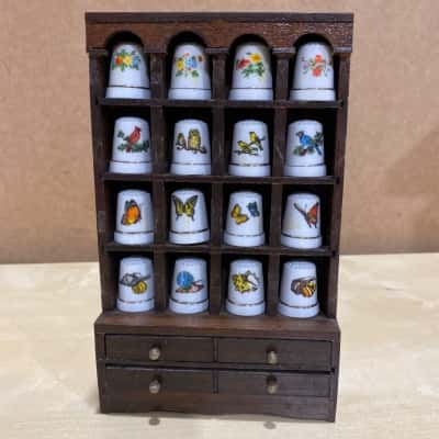 16 decorative thimbles in display case