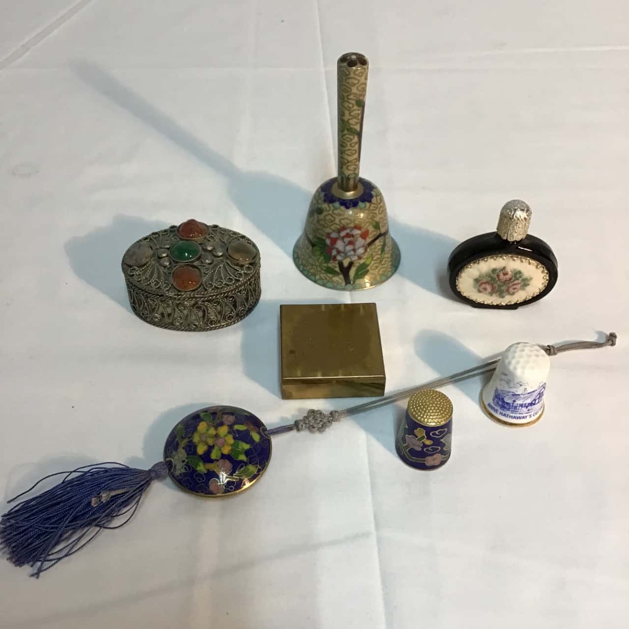 2 assorted items incl. trinket boxes, thimbles, bell,bottle(s)