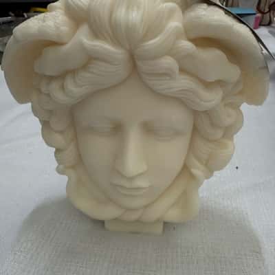 Medusa head candle, a decorative item inspired by the Greek mythological figure.  It is typically made from wax, often soy wax.Home decor item but can be lit.(B9)