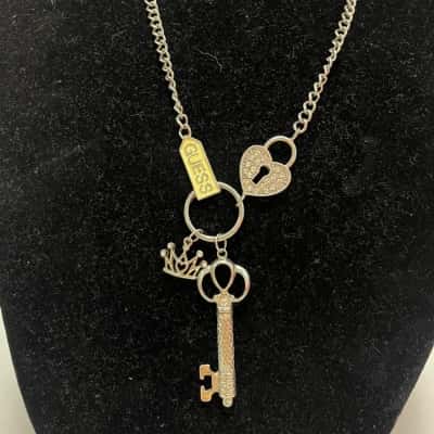 Silver Tone Guess Necklace With Heart Locket, Key, Crown and Tag