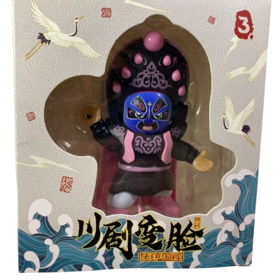 blue-faced Sichuan Opera face-changing figurine in a decorative box, representing the traditional Chinese art of bian lian
