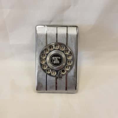 Vintage Mechanical Flip-up Telephone Directory/Rotary Index Features Chrome/Metallic Faceplate With A Classic Retro Telephone Illustration 