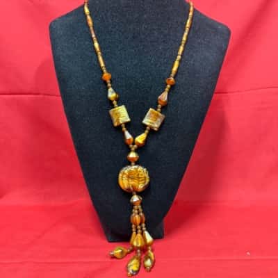 Ladies amber beads with a distinct central pendant and tassel 