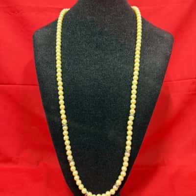 Vintage Faux Pearl necklace features a distinctive silver tone floral clasp 