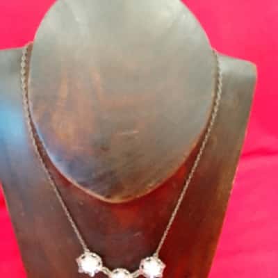 Vintage style necklace featuring three decorative components with white Pearl essence circular centres and delicate chain