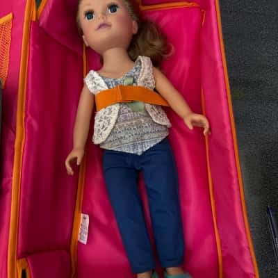18-inch doll,popular size for a brand Our Generation, a doll in a travel carrier, doll has blonde hair, blue eyes, and a soft body. The doll has a blanket and two pillows(B12)