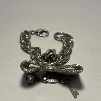 Silver Tone Guess Bracelet With Bow, Heart, Gem And Key Charms
