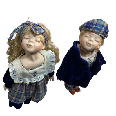 two vintage porcelain "kissing" dolls, a boy and a girl, often referred to as "Kissing Couple" or "Kissing Dolls"