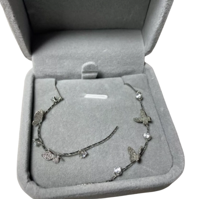  silver-toned long ear climber featuring delicate butterfly motifs and sparkling cubic zirconia crystals