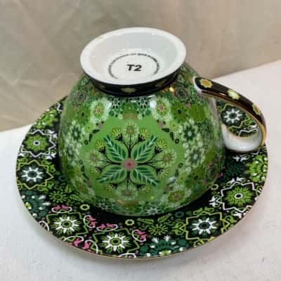 patterned teacup and saucer set, likely from the brand T2, as indicated by the "T2" mark on the bottom of the cup.