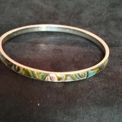 Women's silver toned bangle with abalone look inlay