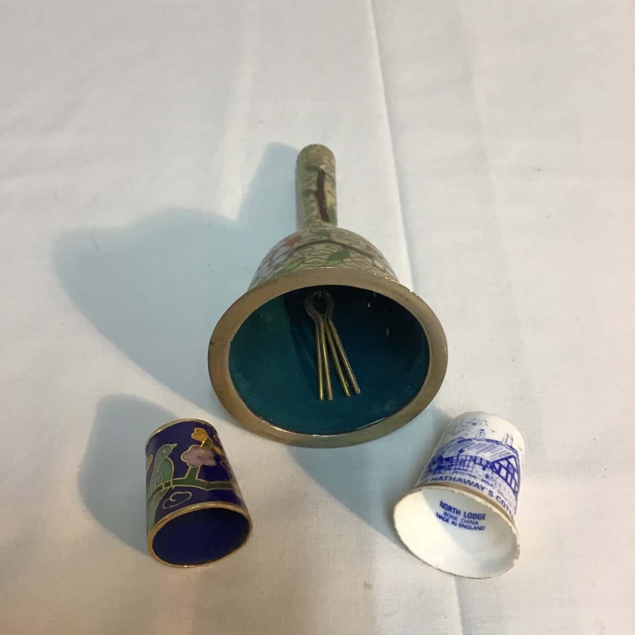 2 assorted items incl. trinket boxes, thimbles, bell,bottle(s)