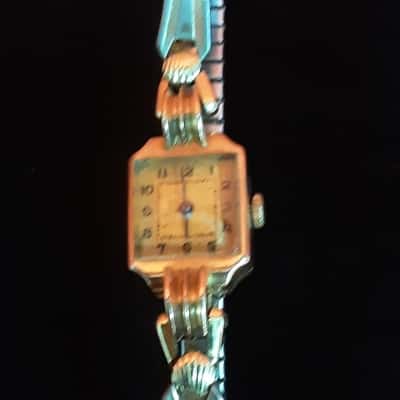 Women's vintage watch featuring a 9ct gold filled case and flexible metal band mid-century collectible