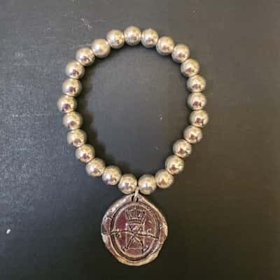 Cat Hammill Silver Alloy elastic bracelet "wisdom outweighs wealth"