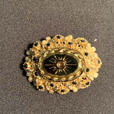 Vintage Sphinx Brooch, gold toned filigree with black enamel and rhinestones with starburst centre