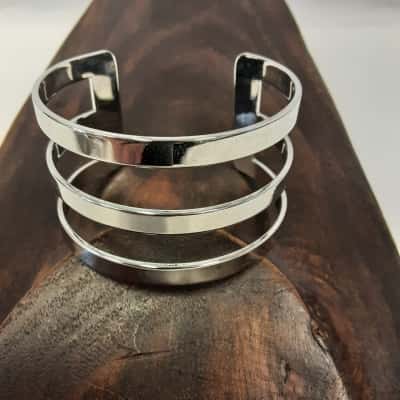 Polish silver tone triple ban metal cuff bracelet with open design