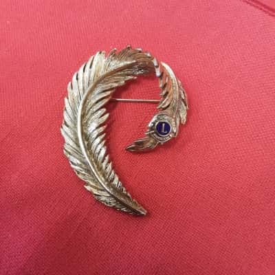 Vintage Lions International Club brooch featuring a gold tone  design and lions logo