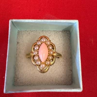  Women's Gold Tone Dress Ring featuring a Pink Central Stone Boarded by Faux Pearls