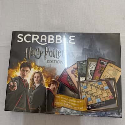 Scrabble Harry Potter Edition board game by Mattel.Includes a special Hogwarts board, 4 racks, letter tiles, and a unique Harry Potter word list.(B25)