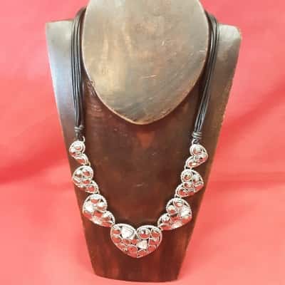 Ladies necklace featuring a large heart pendant surrounded by smaller hearts adorned with black and clear rhinestones on a multi-strand black cord