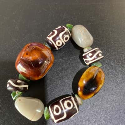  Women’s “Dzi” beads bracelet, amber coloured stone and small green spacer beads
